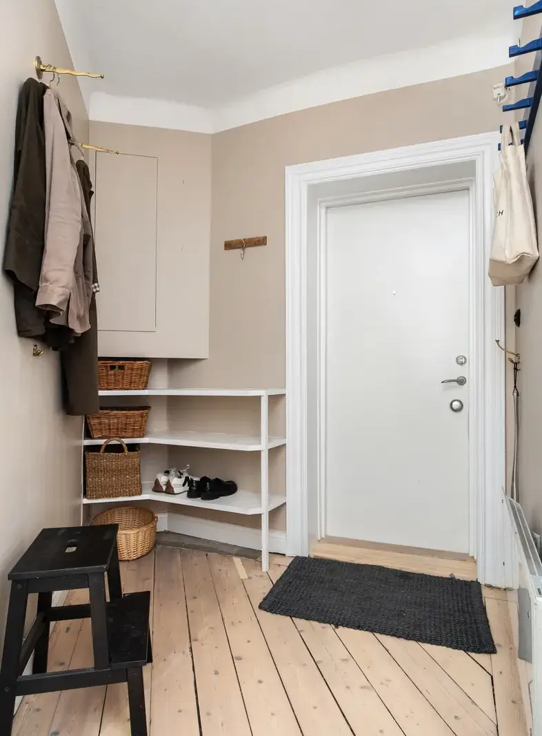 Warm Colors and an Open-Plan Living Space in a Stockholm Apartment 15 hall with storage