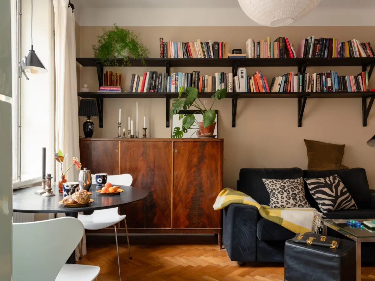 Warm Beige Walls and Practical Niches in a 1920s Studio Apartment 6 high bookshelves studio apartment