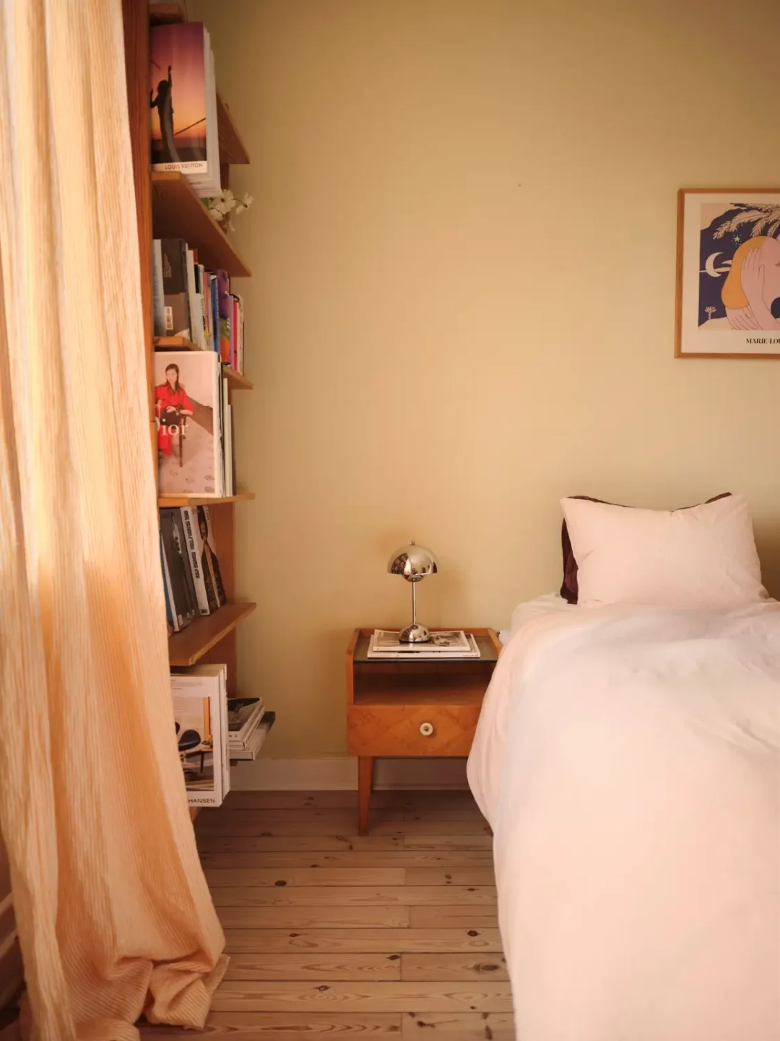 Soft Beige Interiors with the Occasional Bright Color Pop in Stockholm 20 honey-beige bedroom wooden floor bookshelves