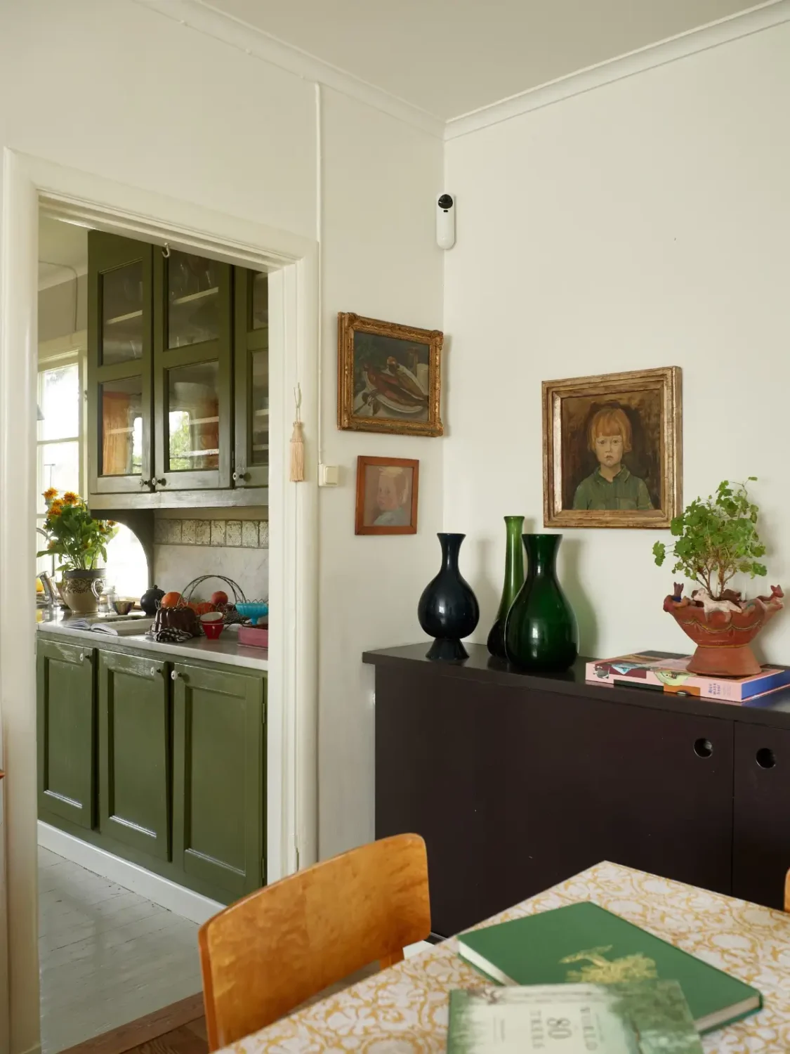 A Well-Preserved 1920s House with a Green Kitchen in Stockholm 7 kitchen dining room