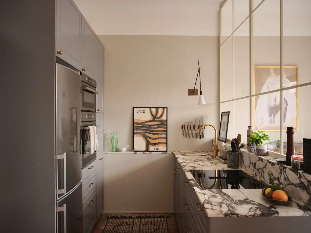 Warm Pink Walls and a Glass Room Divider in a Small Stockholm Apartment 19 kitchen gray cabinets marble countertop brass fittings