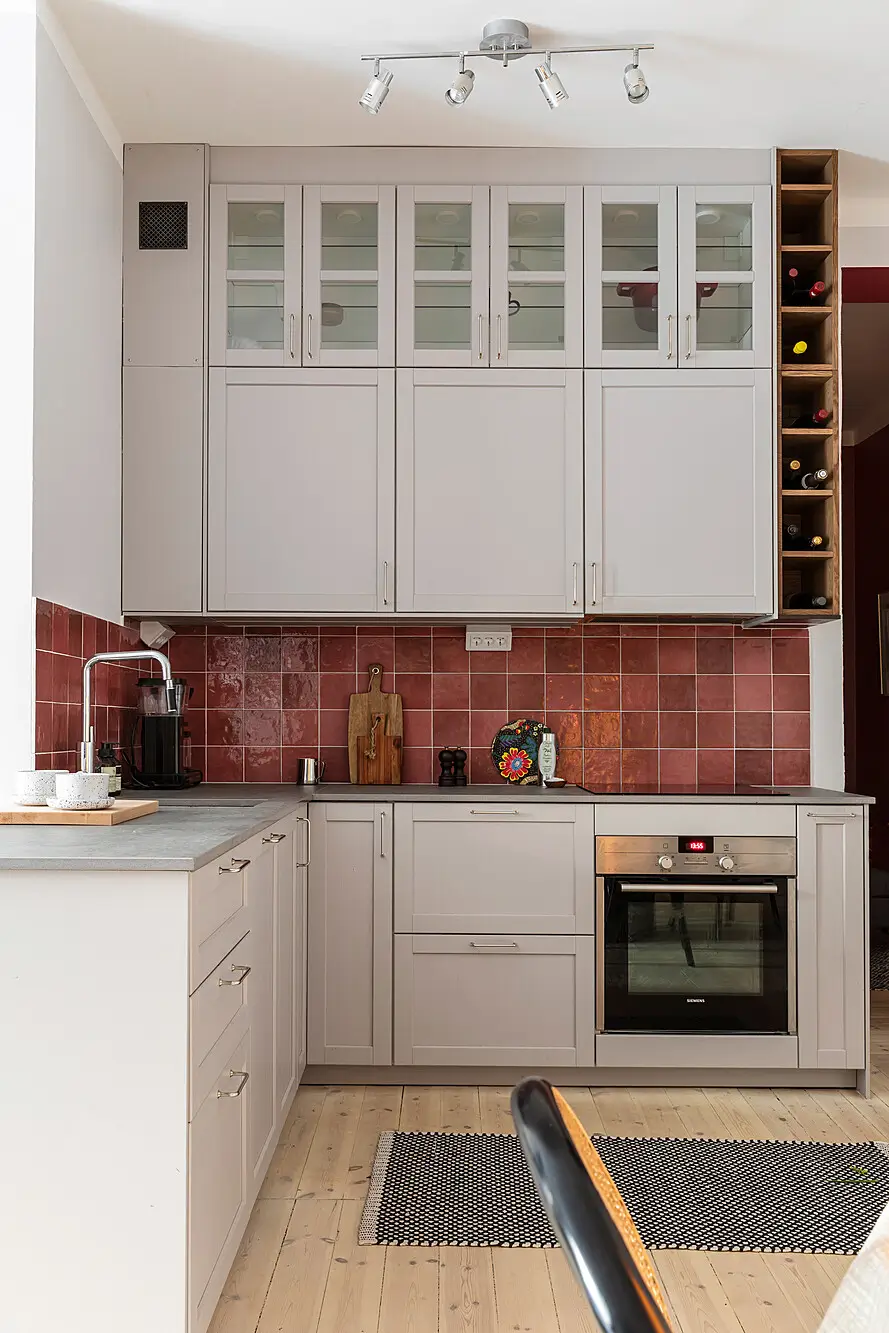 Red and Blue Color Accents in an Open-Plan Stockholm Apartment 10 kitchen light gray cabinets red backsplash tiles nordroom
