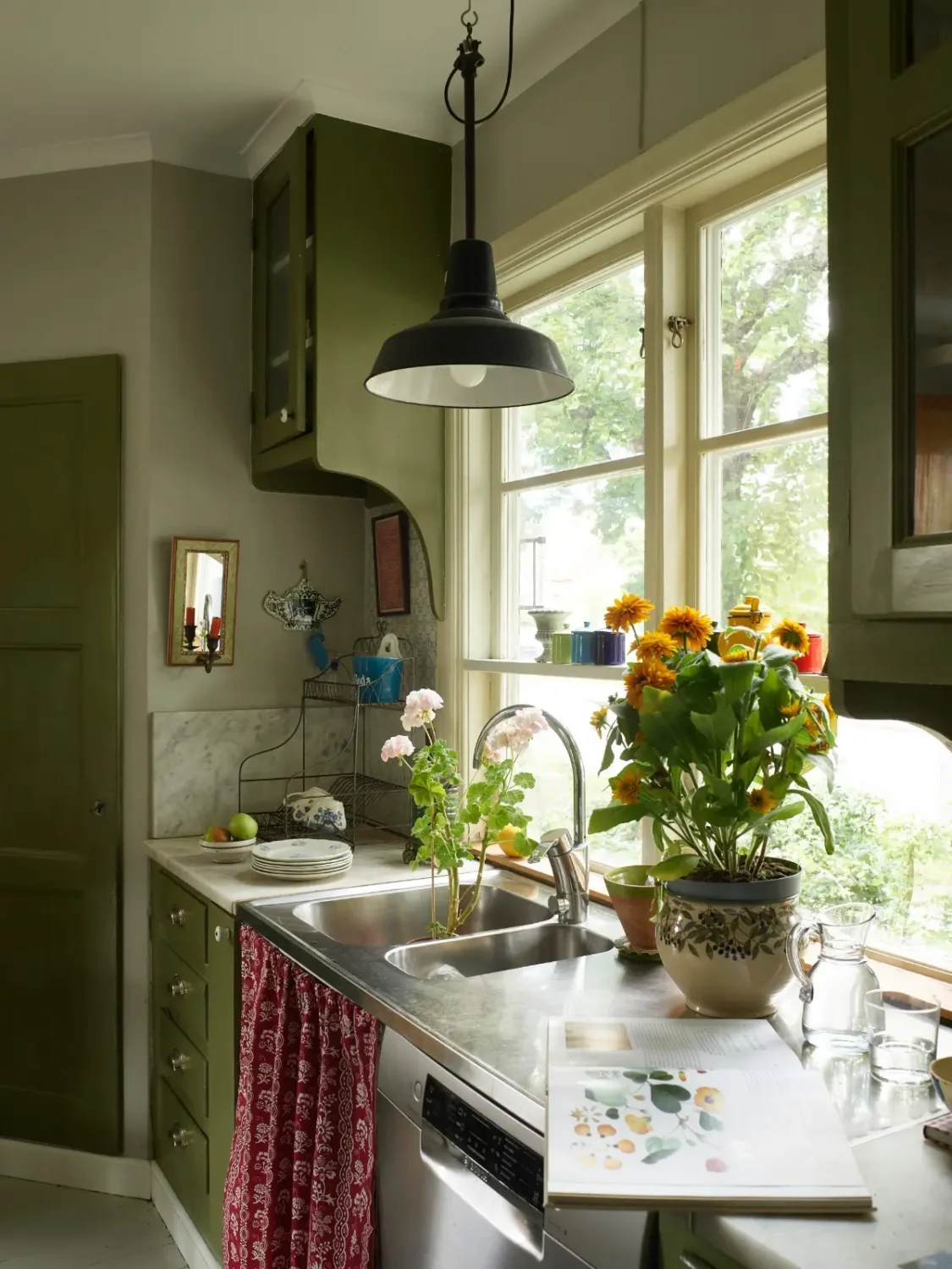 A Well-Preserved 1920s House with a Green Kitchen in Stockholm 3 kitchen sink window with shelf