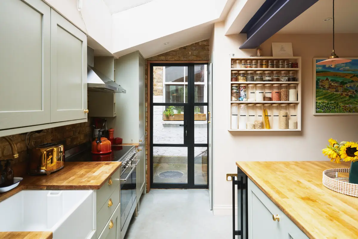 An Extended Victorian Apartment with Exposed Brick Walls 10 kitchen steel door