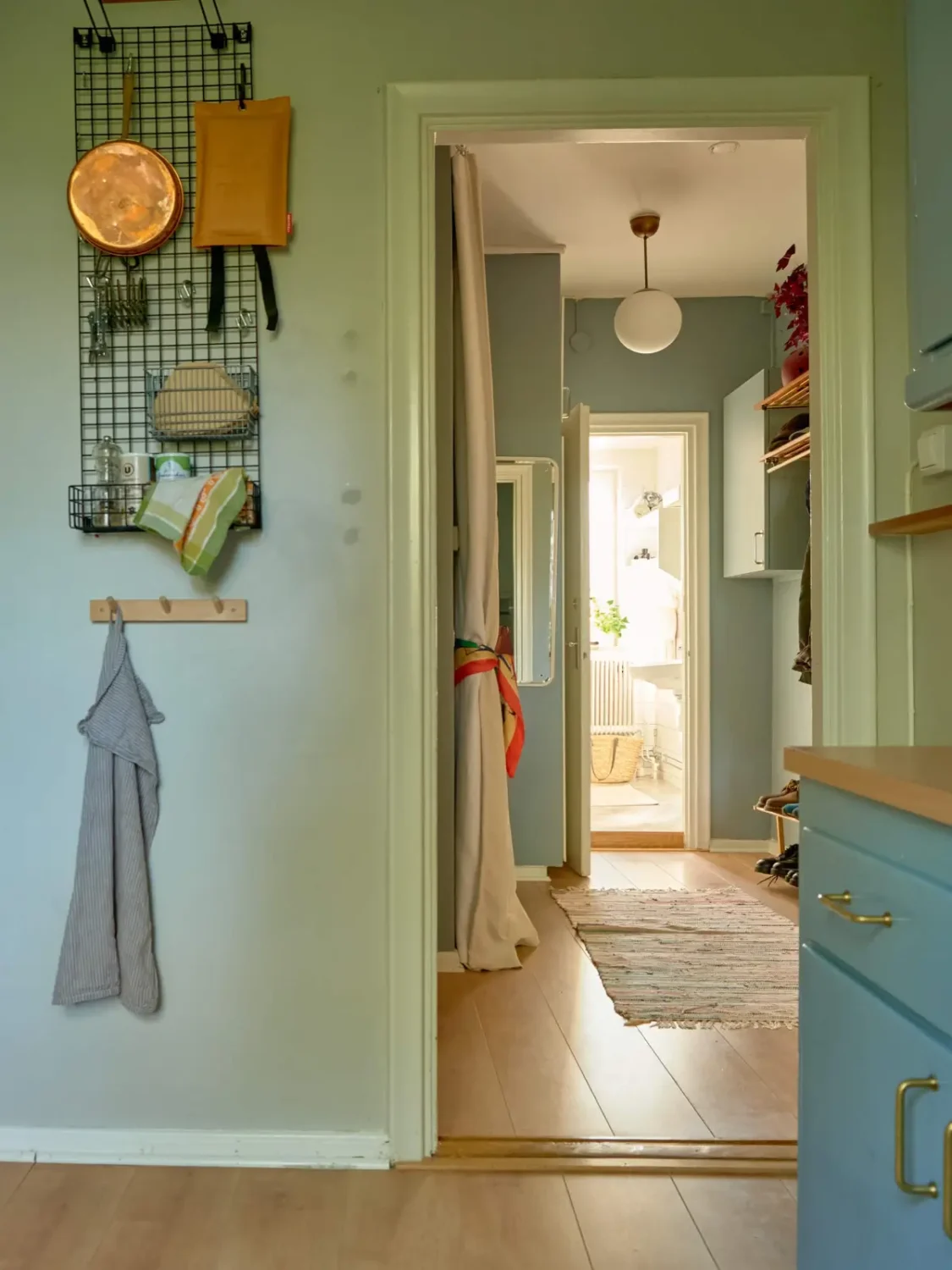 A Colorful and Cozy Midcentury Apartment in Stockholm 13 kitchen view into hall