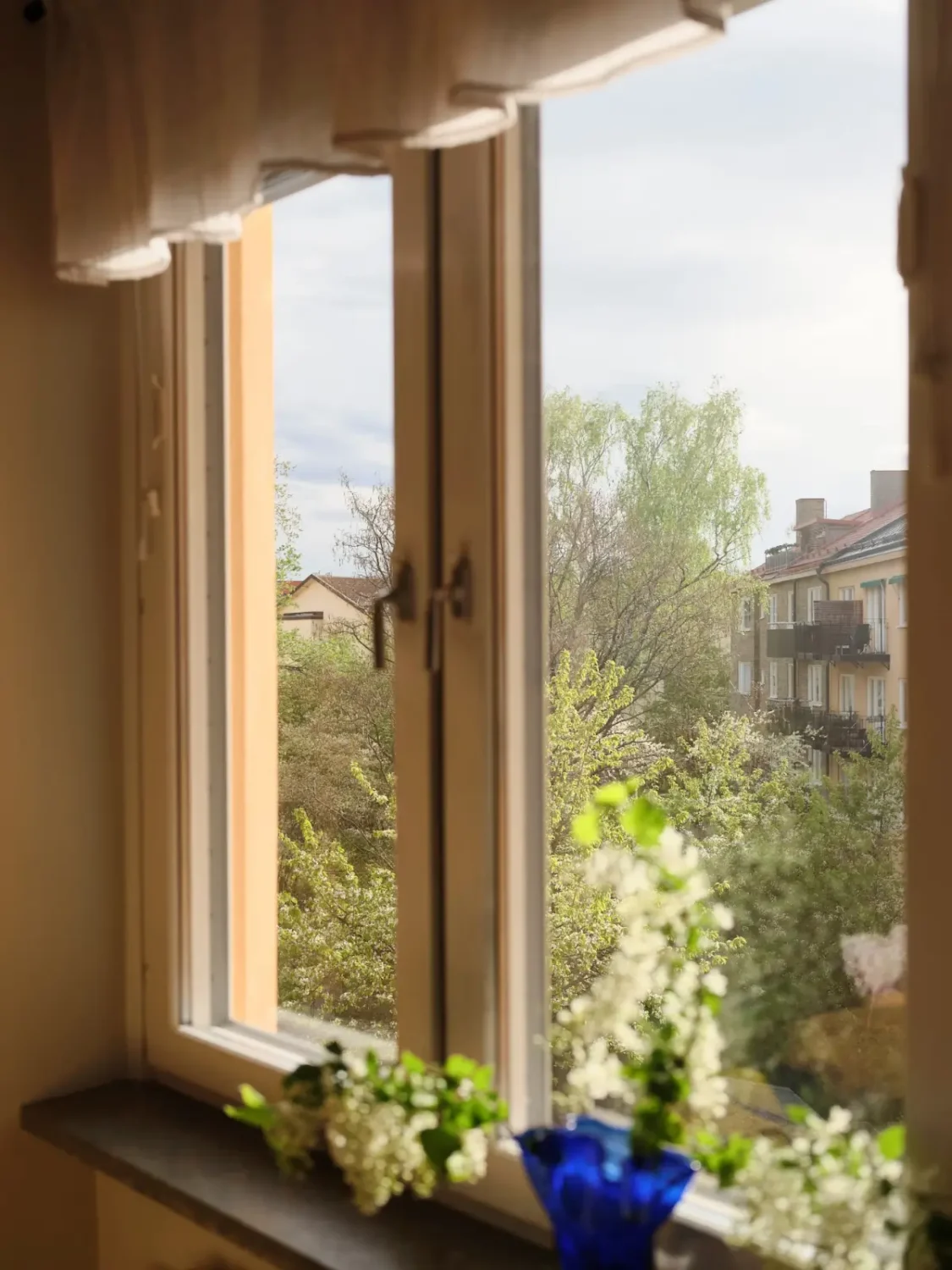 Soft Beige Interiors with the Occasional Bright Color Pop in Stockholm 16 kitchen window view
