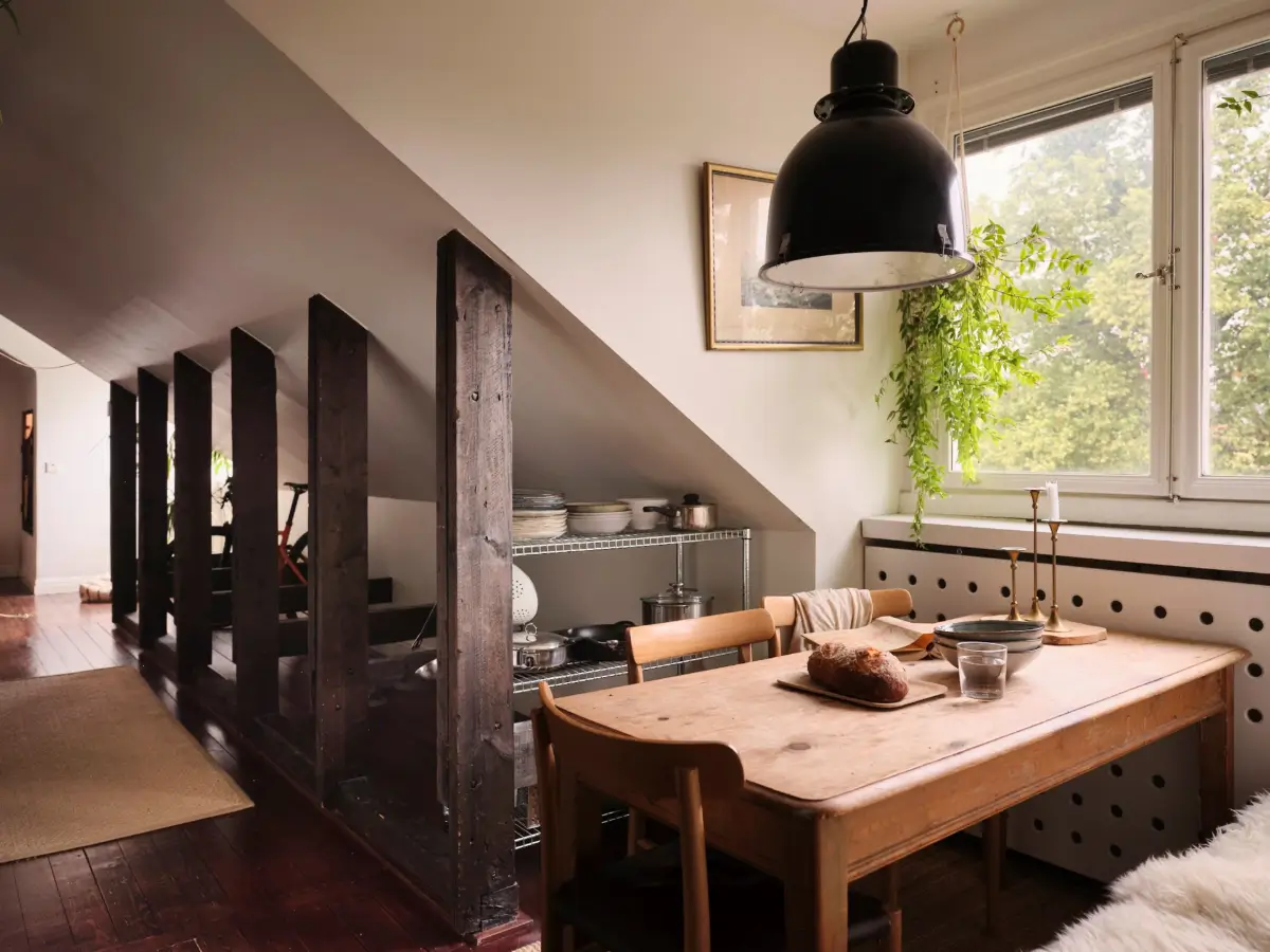 Exposed Beams and Dark-Stained Floorboards in a Cozy Attic Apartment 11 kitchen wooden table