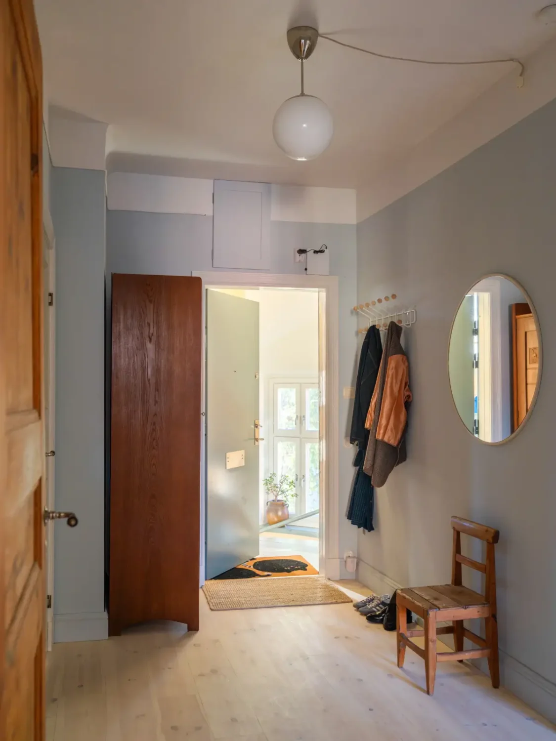 A Bright Apartment Where Historic Character Meets Contemporary Design 33 light blue hall A Bright Apartment Where Historic Character Meets Contemporary Design