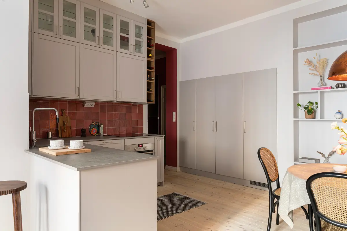 Red and Blue Color Accents in an Open-Plan Stockholm Apartment 11 light gray kitchen reddish-pink backsplash tiles built-in cabinets nordroom
