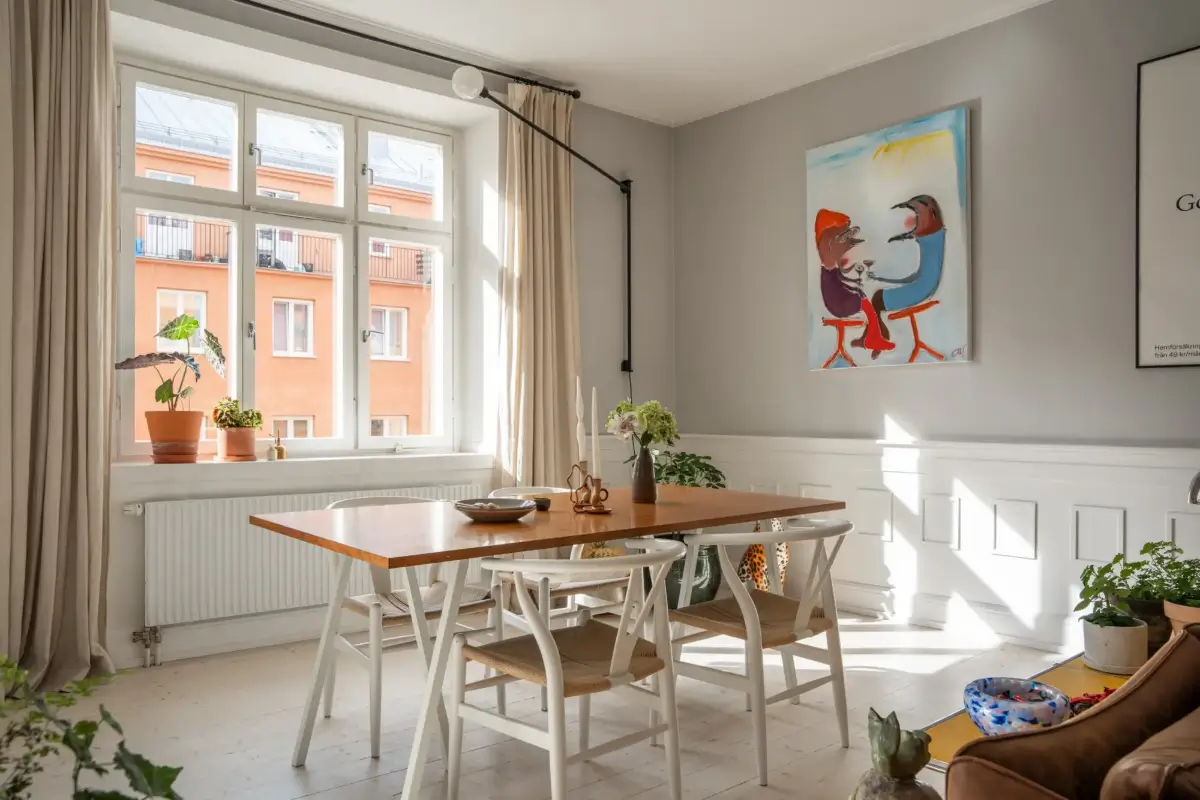 A Light Turn-of-the-Century Apartment with a Blue Kitchen 8 light gray living room dining table