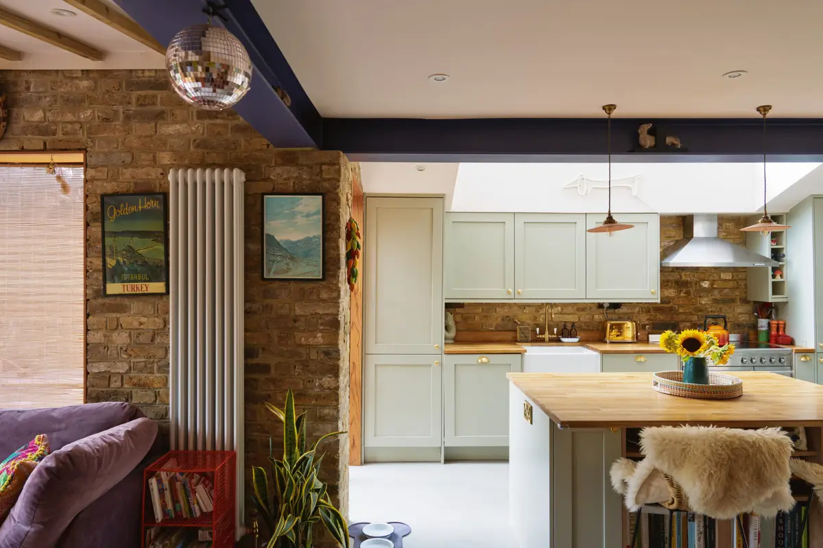 An Extended Victorian Apartment with Exposed Brick Walls 7 light green kitchen with island and brick walls