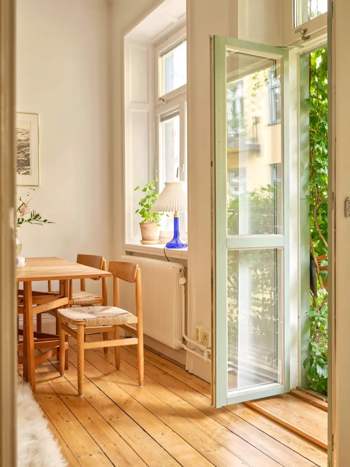 A Lush Balcony and Charming Rooms in a Late 19th Century Apartment 11 living room balcony doors wooden floor