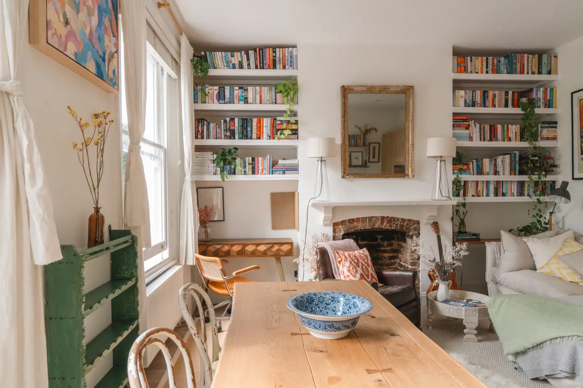 A Bright and Cozy One-Bedroom Apartment in London 3 living room brick fireplace built-in shelves