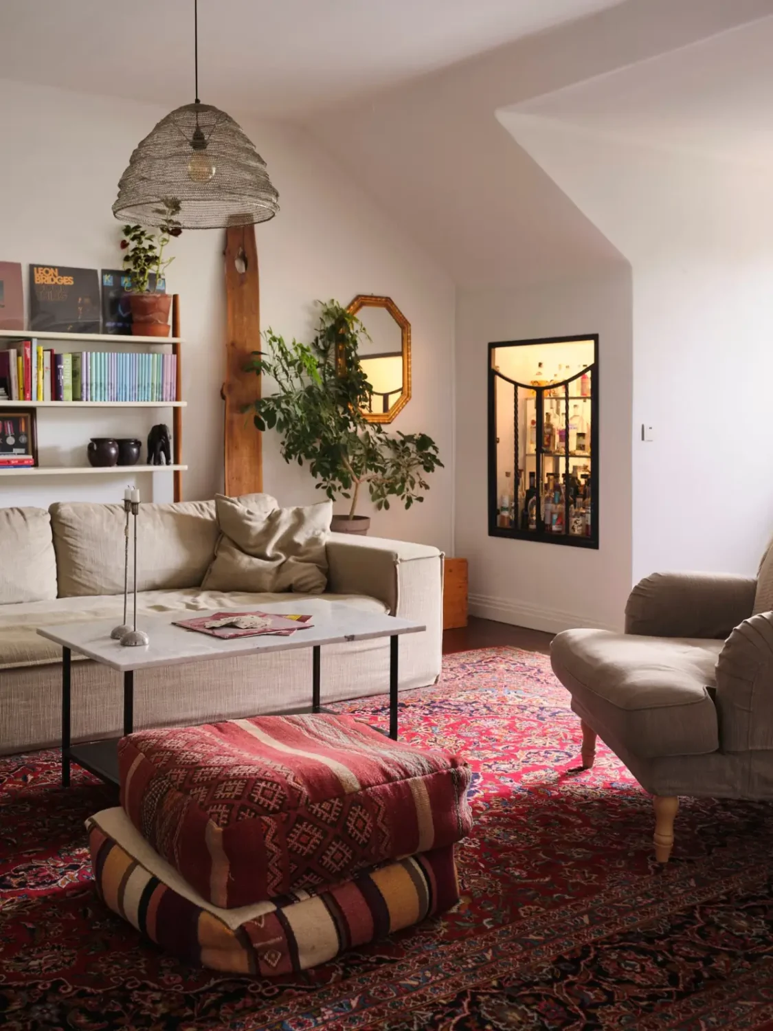 Exposed Beams and Dark-Stained Floorboards in a Cozy Attic Apartment 5 living room built-in home bar