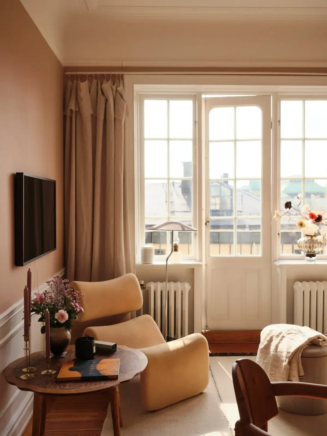 Warm Pink Walls and a Glass Room Divider in a Small Stockholm Apartment 8 living room chair