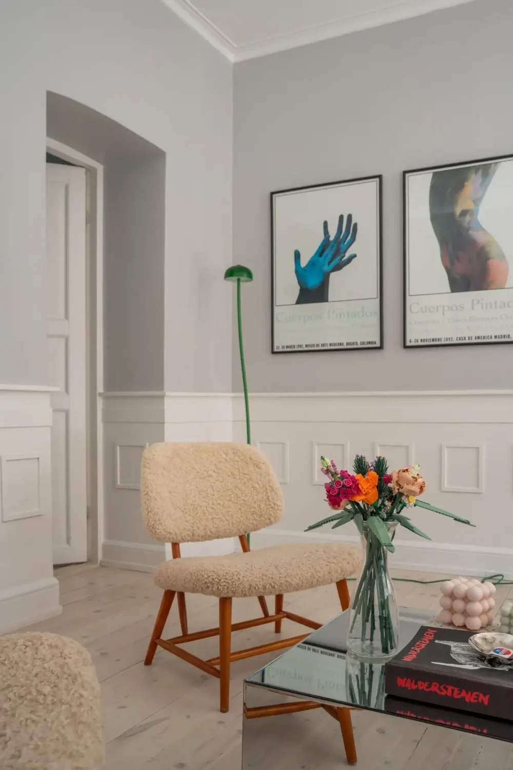 A Light Turn-of-the-Century Apartment with a Blue Kitchen 3 living room chairs
