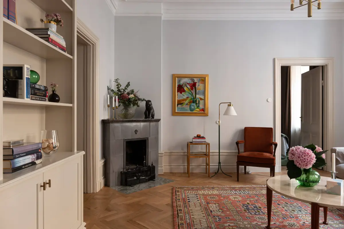 A Luxurious Family Apartment with a Dramatic Black Bathroom 4 living room fireplace light blue walls