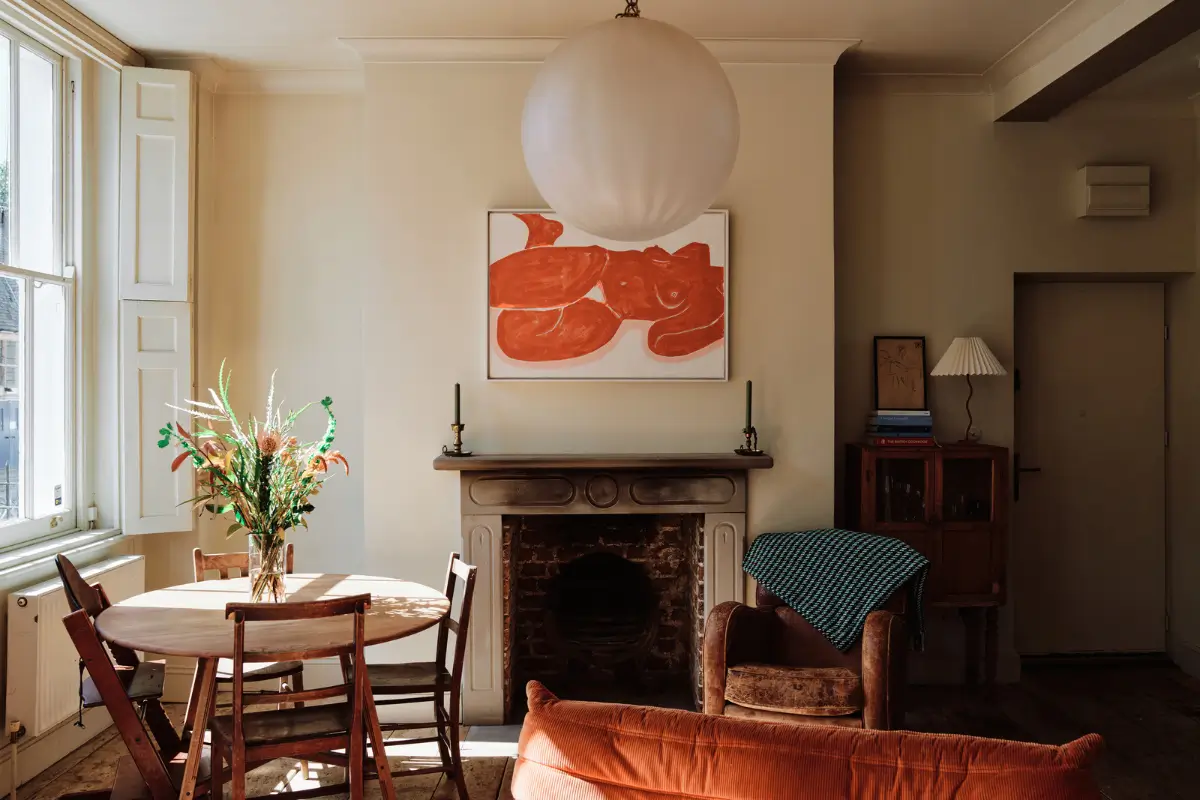 Restored Features in a Charming Georgian Apartment in London 2 living room fireplace round table