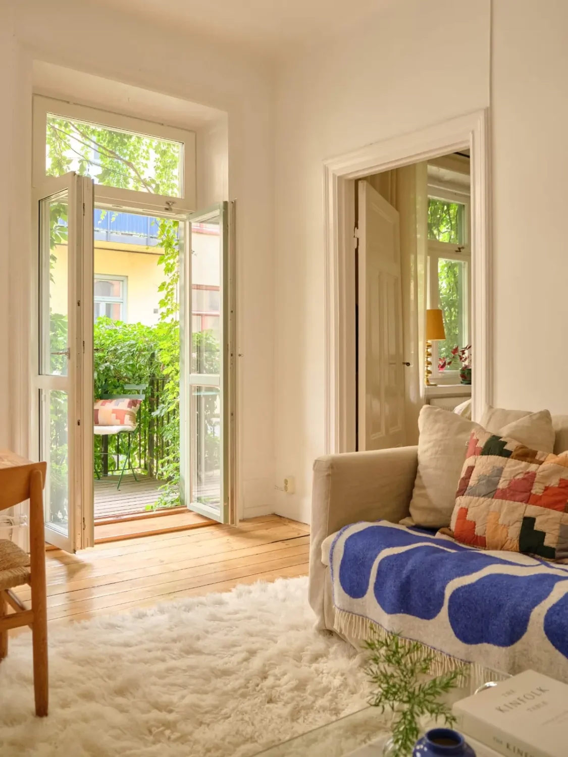 A Lush Balcony and Charming Rooms in a Late 19th Century Apartment 5 living room glass balcony doors