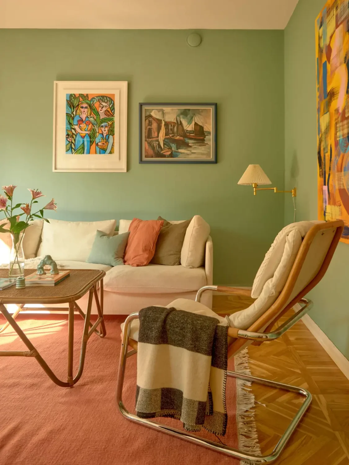 A Colorful and Cozy Midcentury Apartment in Stockholm 3 living room green walls pink rug