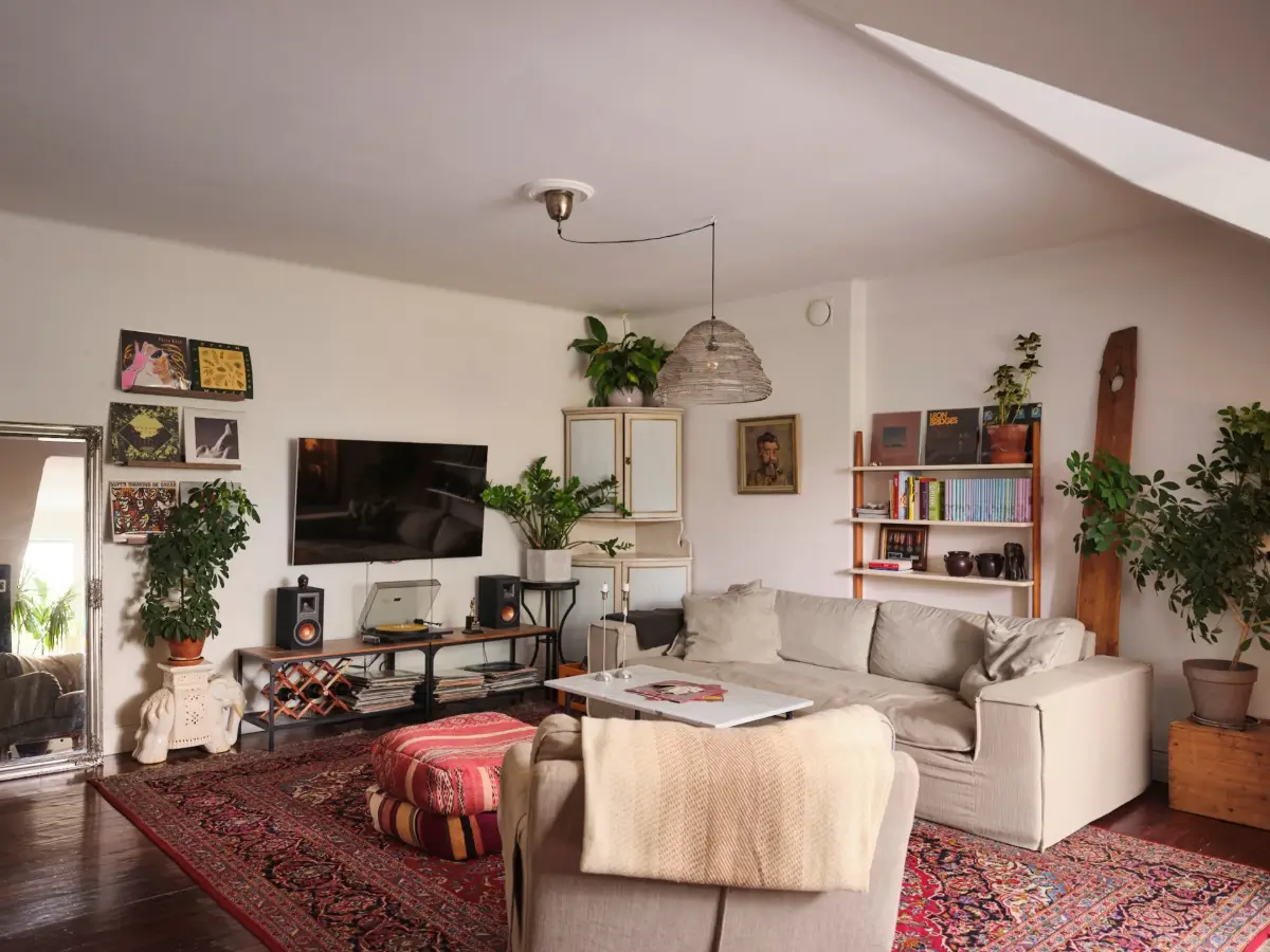 Exposed Beams and Dark-Stained Floorboards in a Cozy Attic Apartment 1 living room large red-pink rug