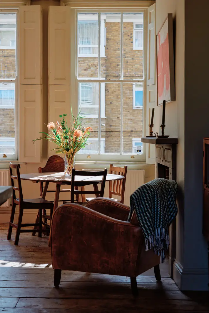 Restored Features in a Charming Georgian Apartment in London 5 living room large windows round table