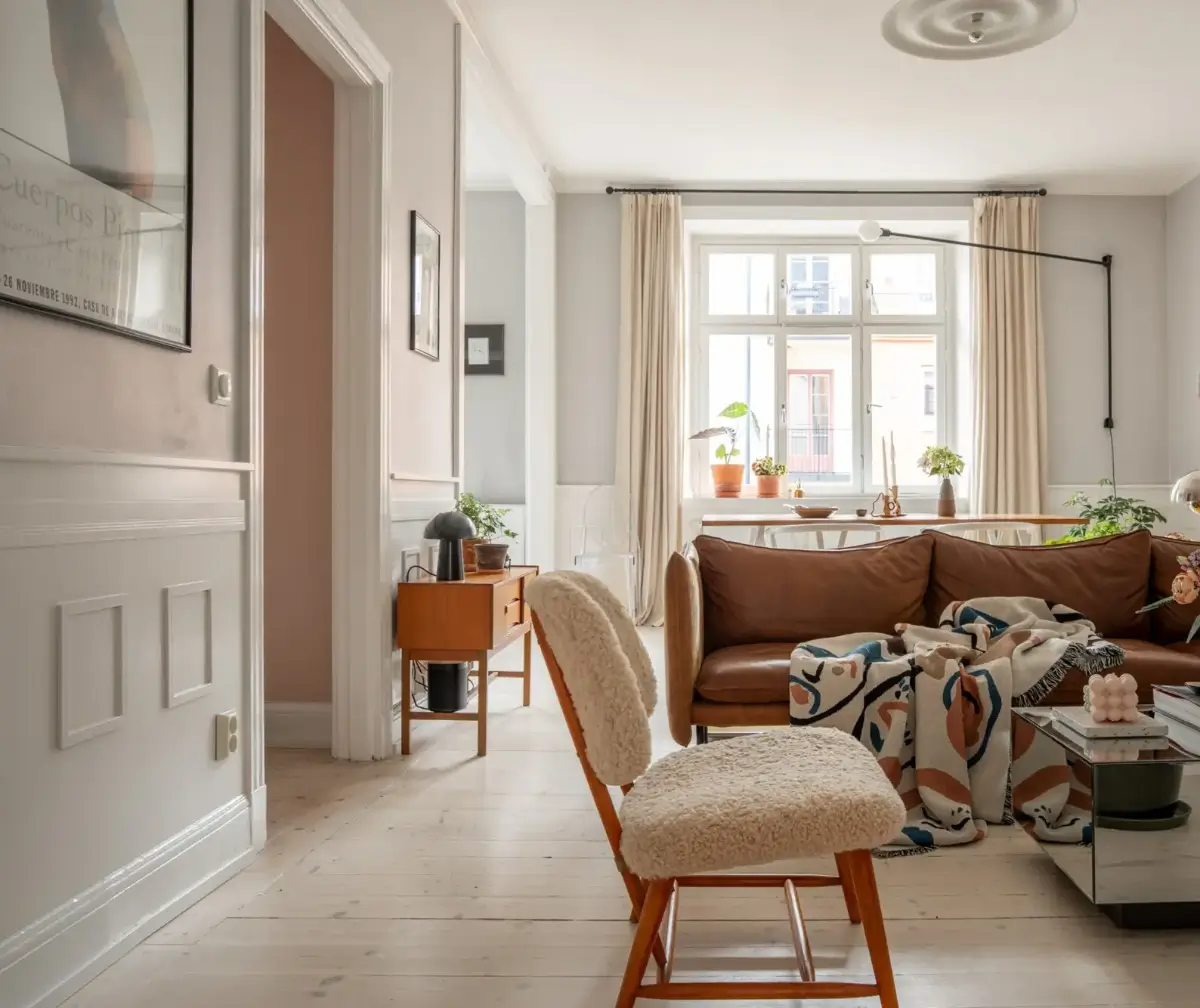 A Light Turn-of-the-Century Apartment with a Blue Kitchen 1 living room tan sof