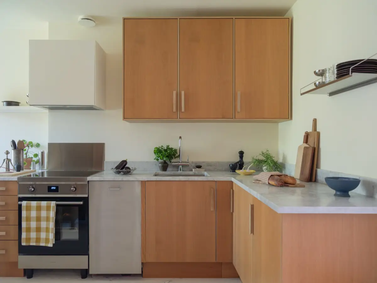 A Bright Apartment Where Historic Character Meets Contemporary Design 20 marble countertop oak cabinets