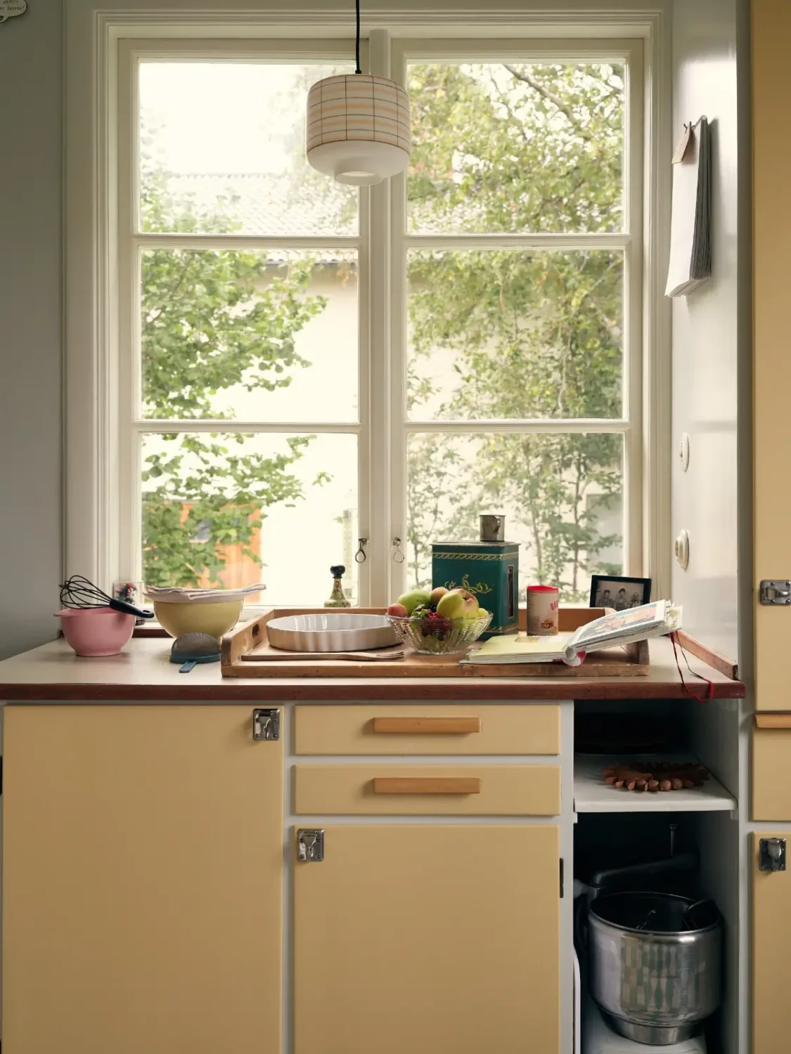 A Cheerful Color Palette in an Early 20th Century Villa in Stockholm 12 midcentury yellow kitchen cabinets