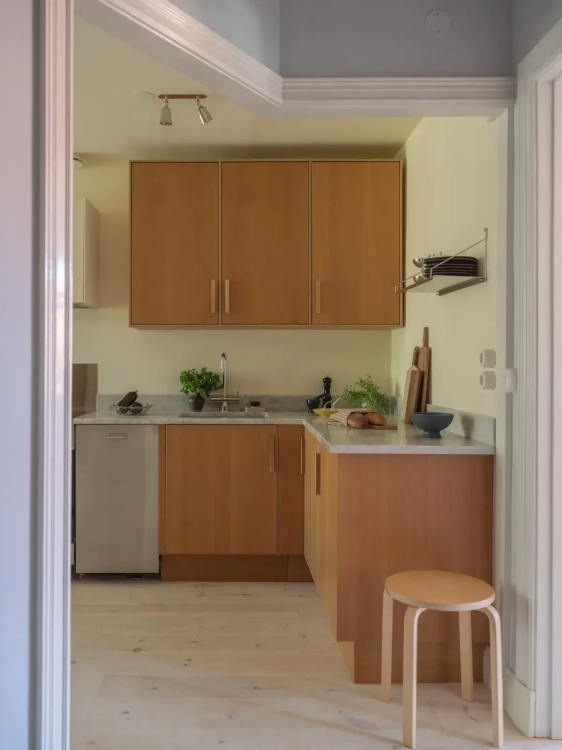 A Bright Apartment Where Historic Character Meets Contemporary Design 18 oak ikea kitchen marble top