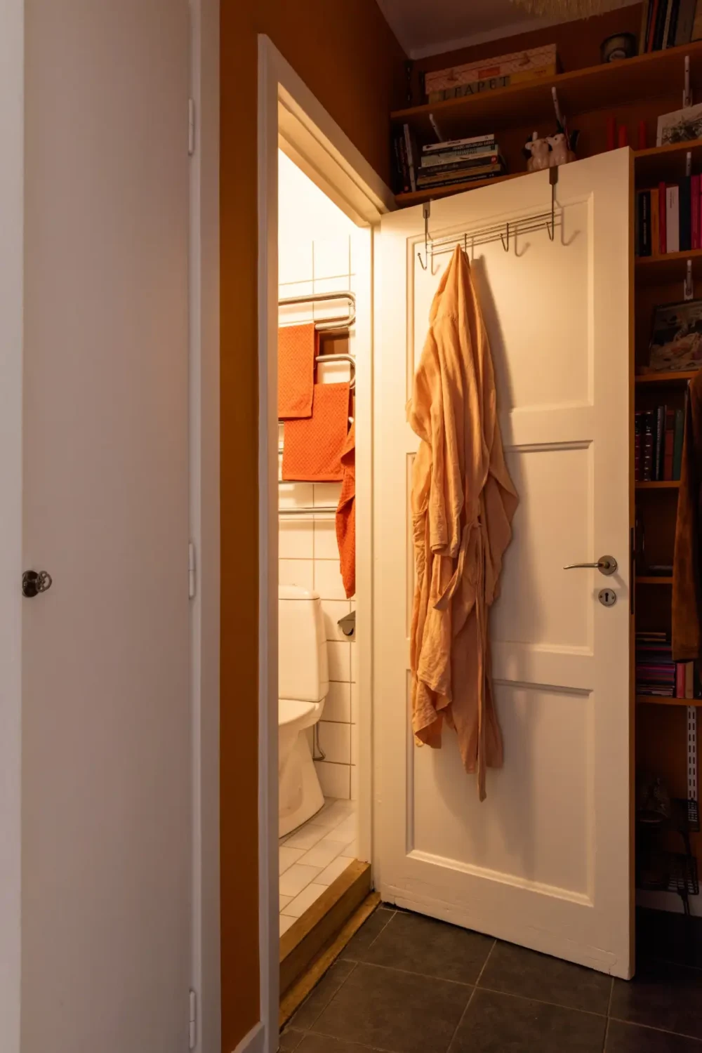 A Warm Beige Studio Apartment with a Butter-Yellow Kitchen 21 ochre hall bathroom door