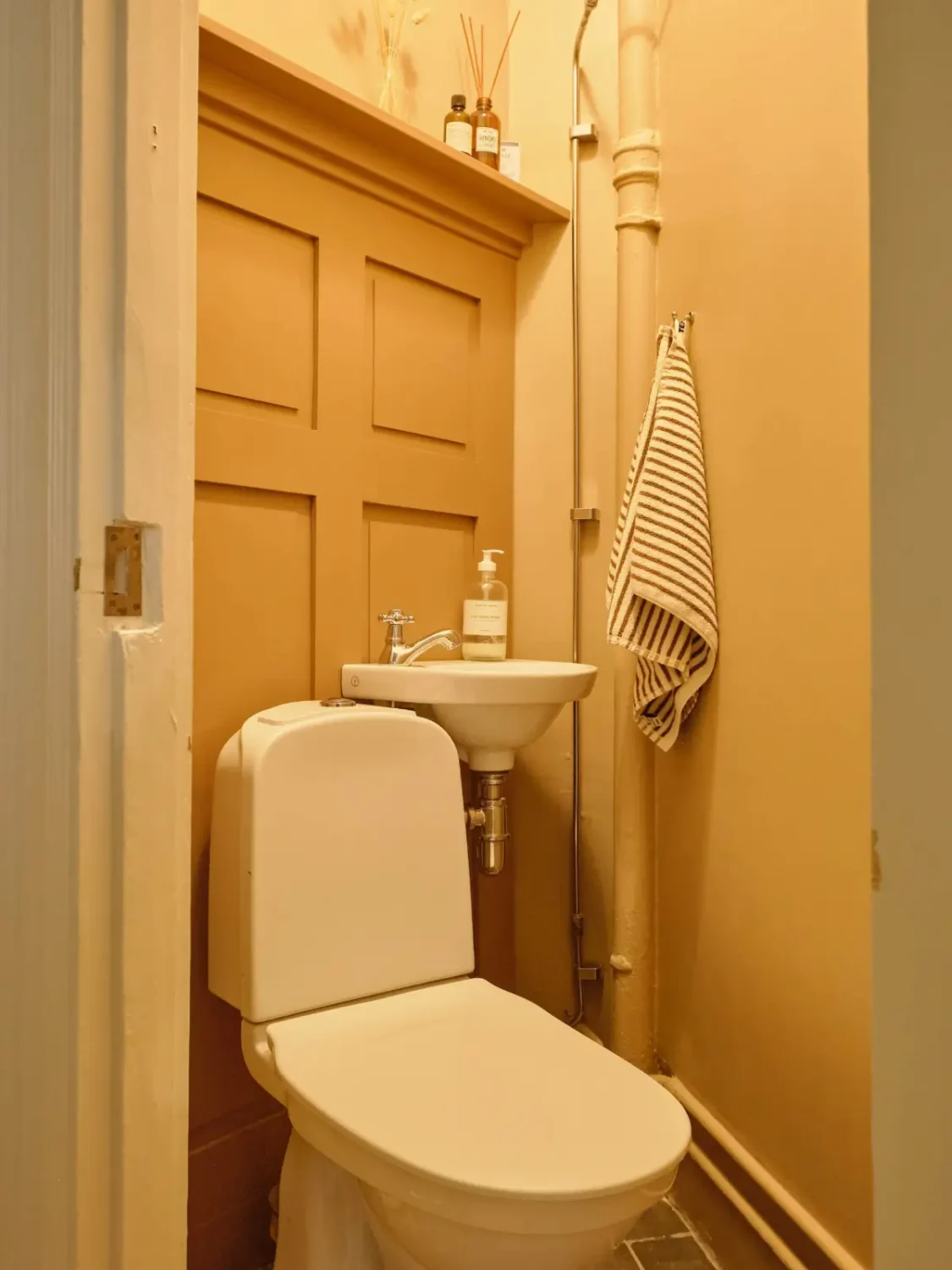 A Lush Balcony and Charming Rooms in a Late 19th Century Apartment 25 ochre yellow guest toilet
