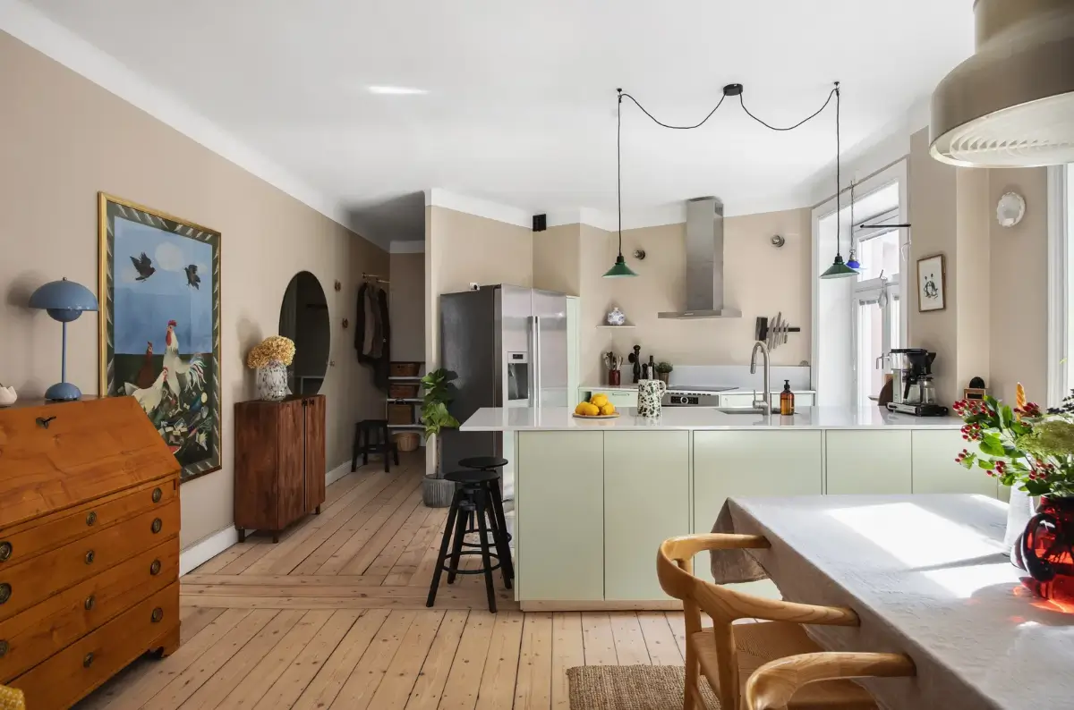 open-plan living space wooden floor mint green kitchen