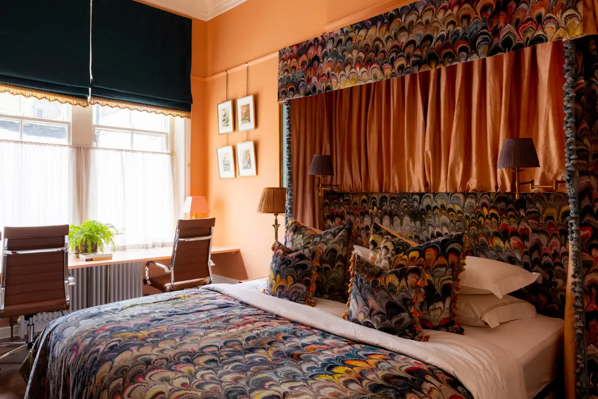 A Mixture of Patterns, Colors, and Materials in a Stunning London Apartment 15 orange bedroom double desk under window