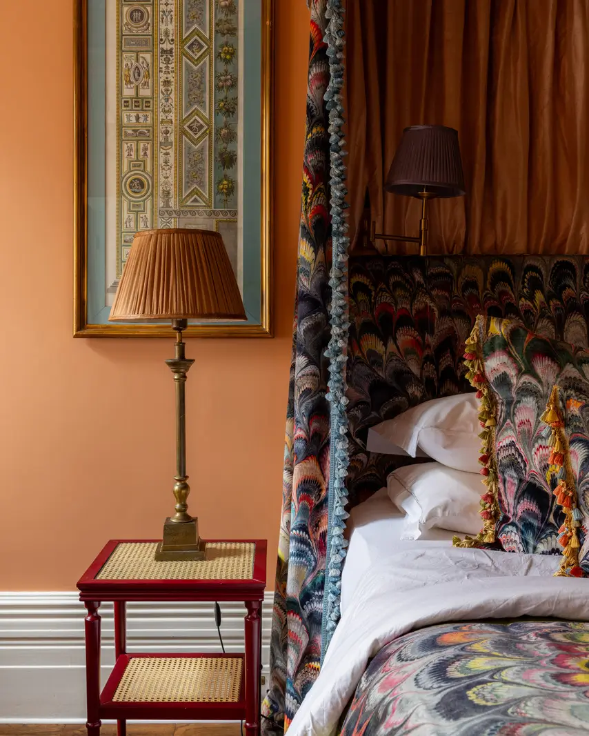 A Mixture of Patterns, Colors, and Materials in a Stunning London Apartment 16 orange bedroom patterned canopy