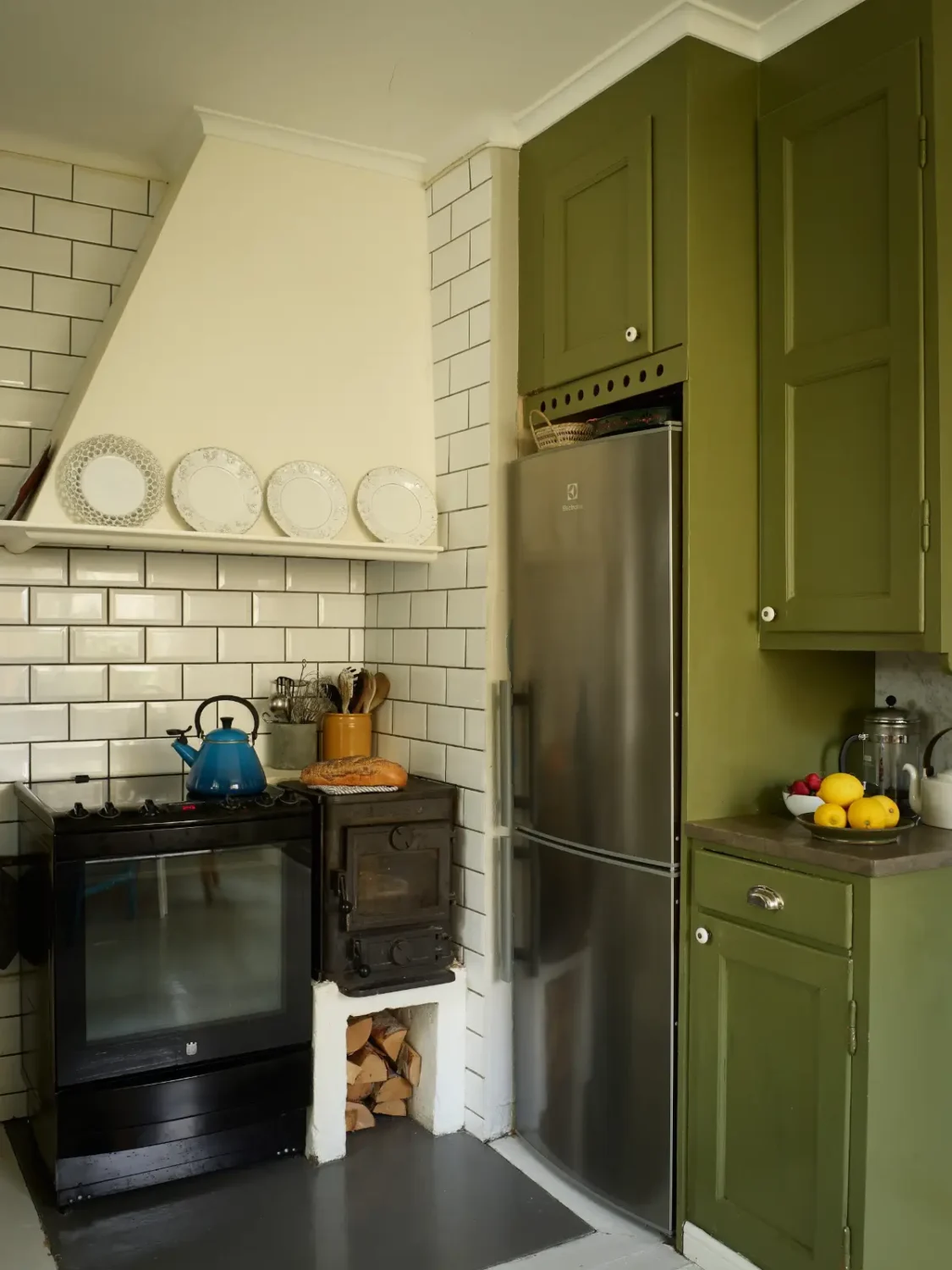 A Well-Preserved 1920s House with a Green Kitchen in Stockholm 6 original kitchen stove green cabinets