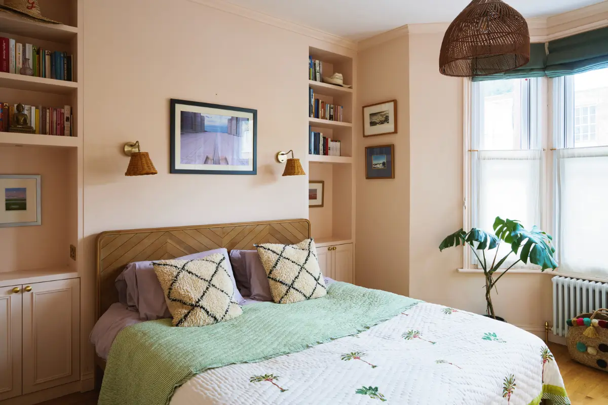 An Extended Victorian Apartment with Exposed Brick Walls 13 pink bedroom bay window built-in shelves cabinets
