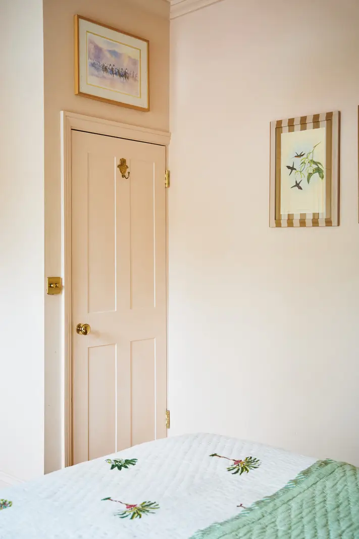 An Extended Victorian Apartment with Exposed Brick Walls 17 pink door built-in wardrobe