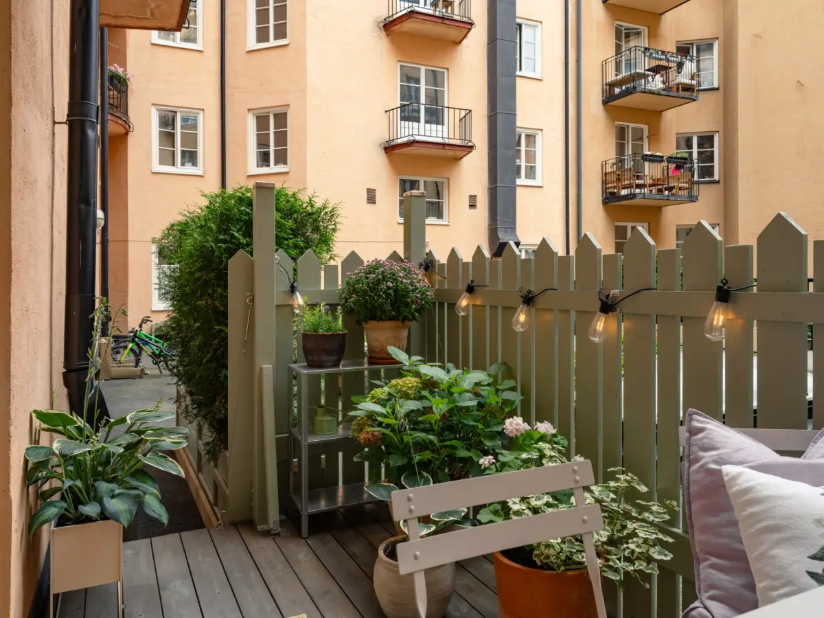 A Light Color Palette and a Charming Private Patio in a Stockholm Apartment 10 private wooden terrace