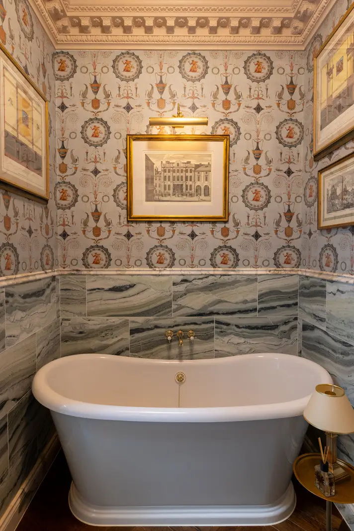 A Mixture of Patterns, Colors, and Materials in a Stunning London Apartment 22 rolltop bath green marble tiles wallpaper