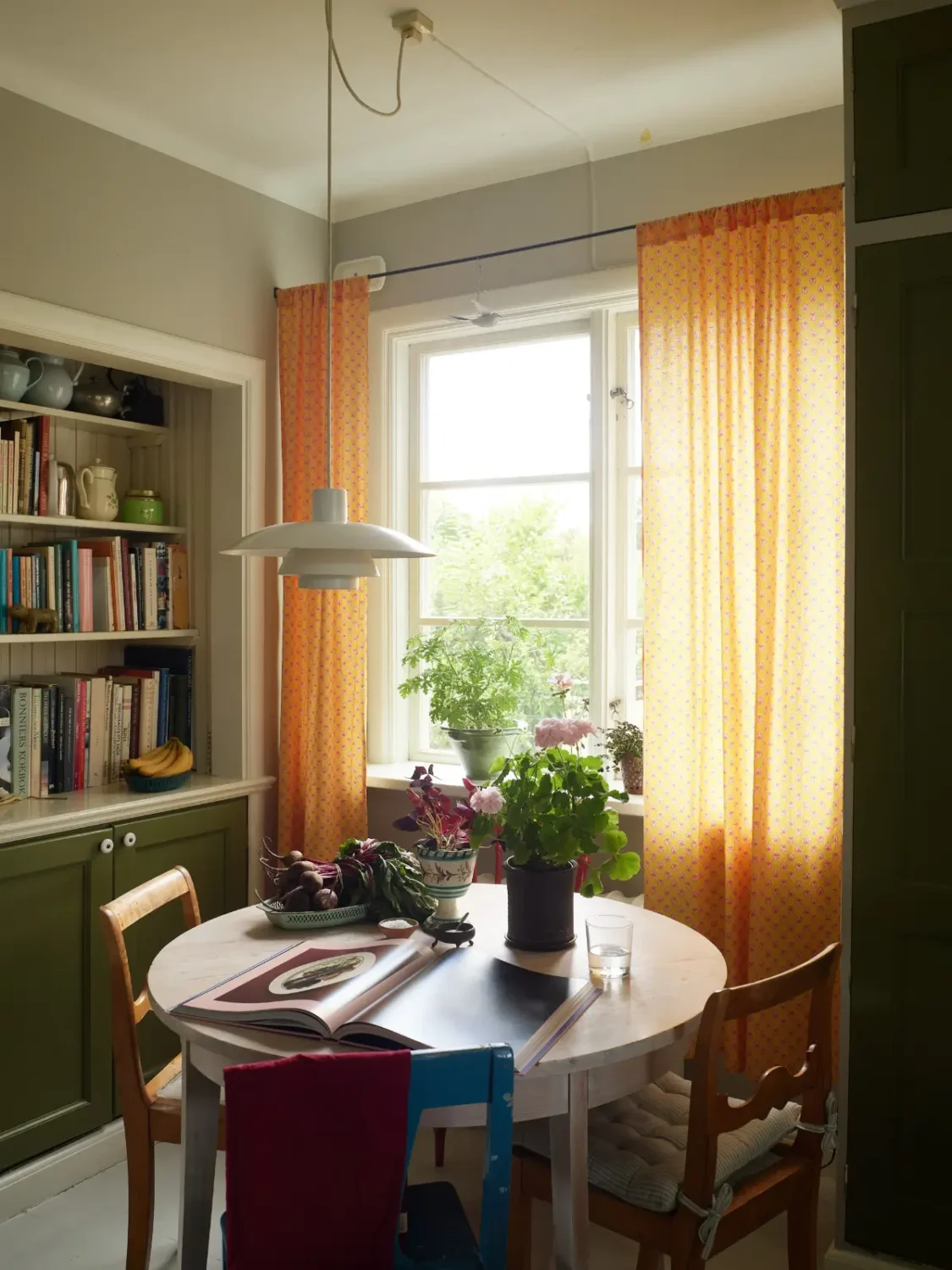 A Well-Preserved 1920s House with a Green Kitchen in Stockholm 4 round kitchen table