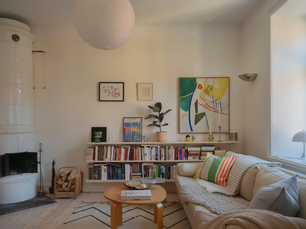 A Bright Apartment Where Historic Character Meets Contemporary Design 6 scandi living room with bookshelves and fireplace