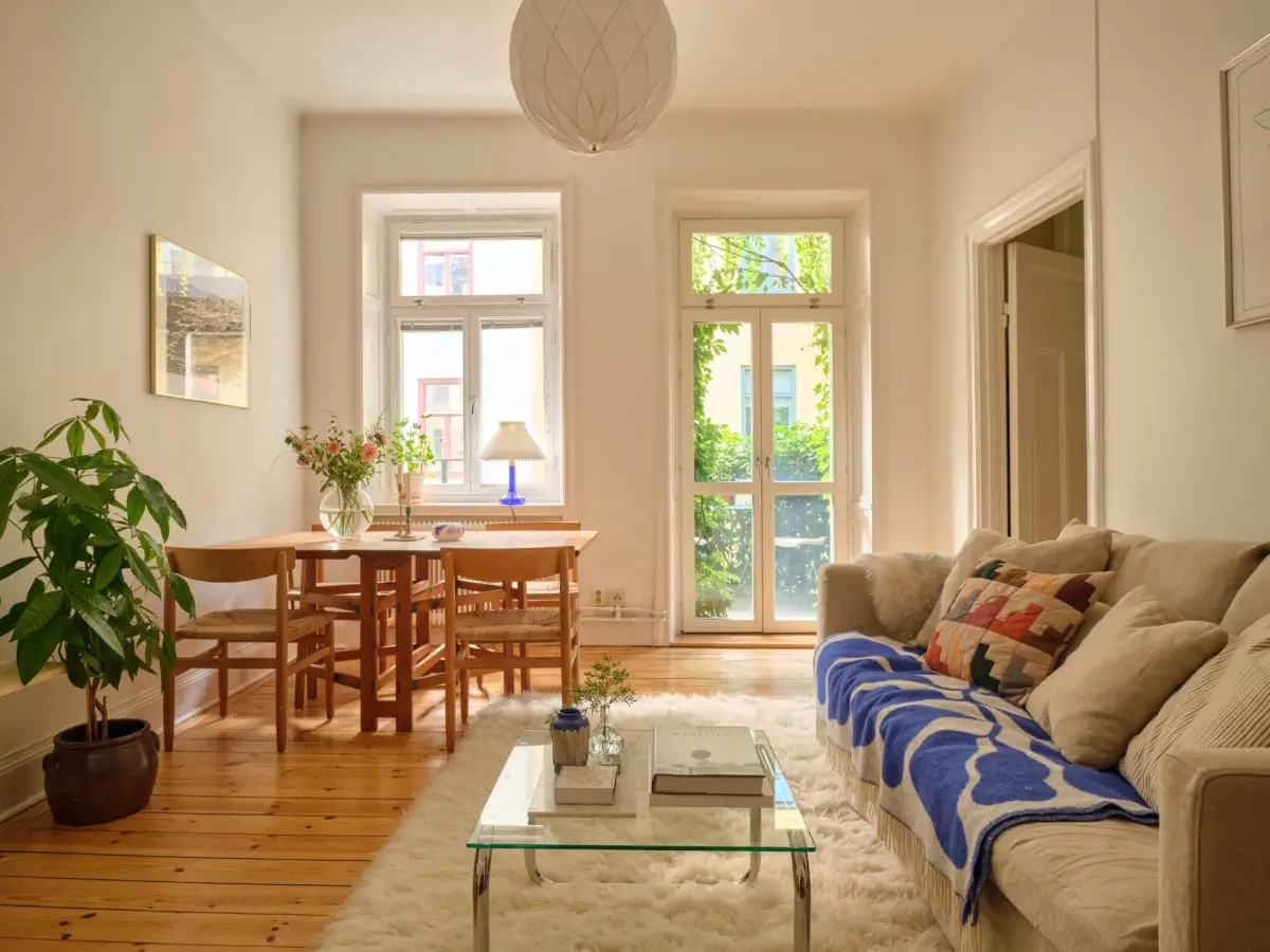 A Lush Balcony and Charming Rooms in a Late 19th Century Apartment 1 serene living room wooden floorboards large table