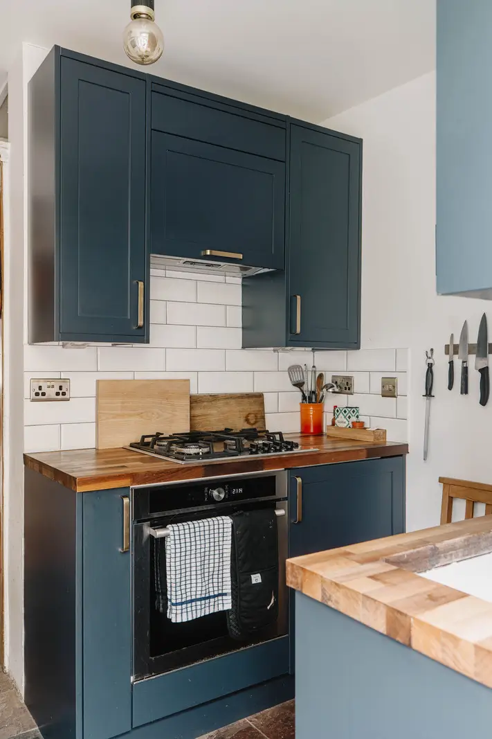 Shades of Blue and Original Details in a Victorian Garden Apartment 11 small kitchen dark blue cabinets