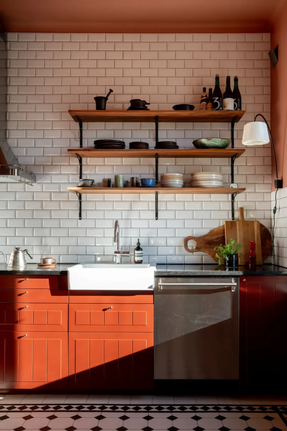 Historic Elegance and a French-Style Kitchen and Bathroom in a Stockholm Apartment 16 small kitchen red cabinets classic black and white floor wooden shelves butler sink nordroom