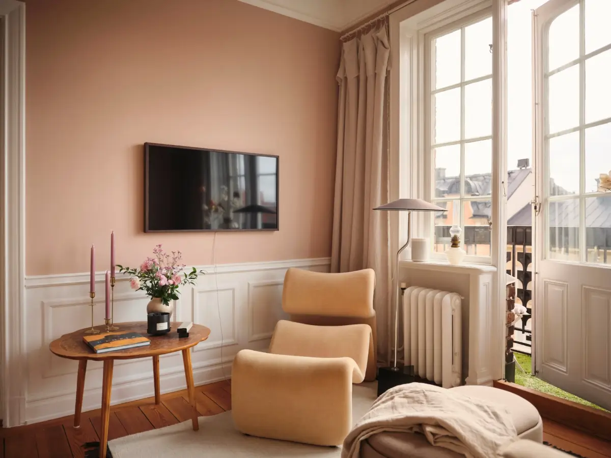 Warm Pink Walls and a Glass Room Divider in a Small Stockholm Apartment 9 small sitting room lounge chair warm pink walls nordroom