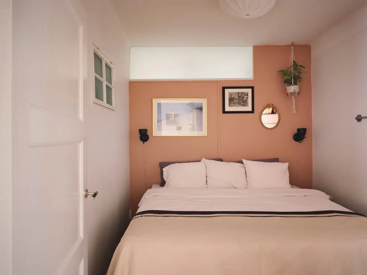 Exposed Beams and Dark-Stained Floorboards in a Cozy Attic Apartment 15 tiny bedroom terracotta wall