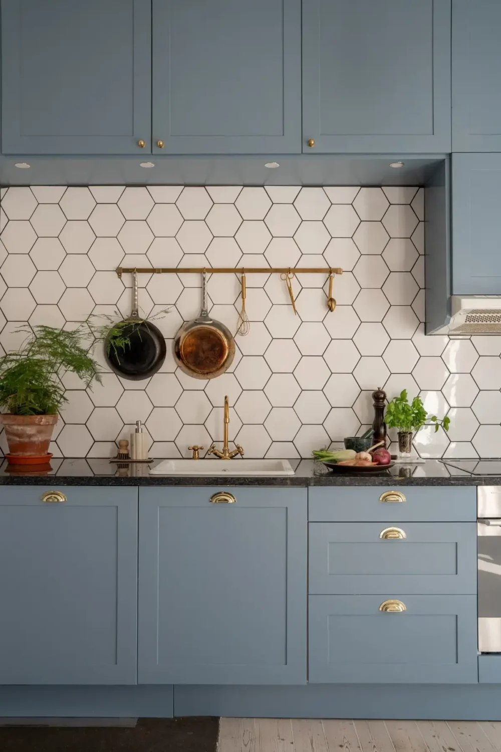 A Light Turn-of-the-Century Apartment with a Blue Kitchen 12 white hexagon backsplash tiles blue kitchen