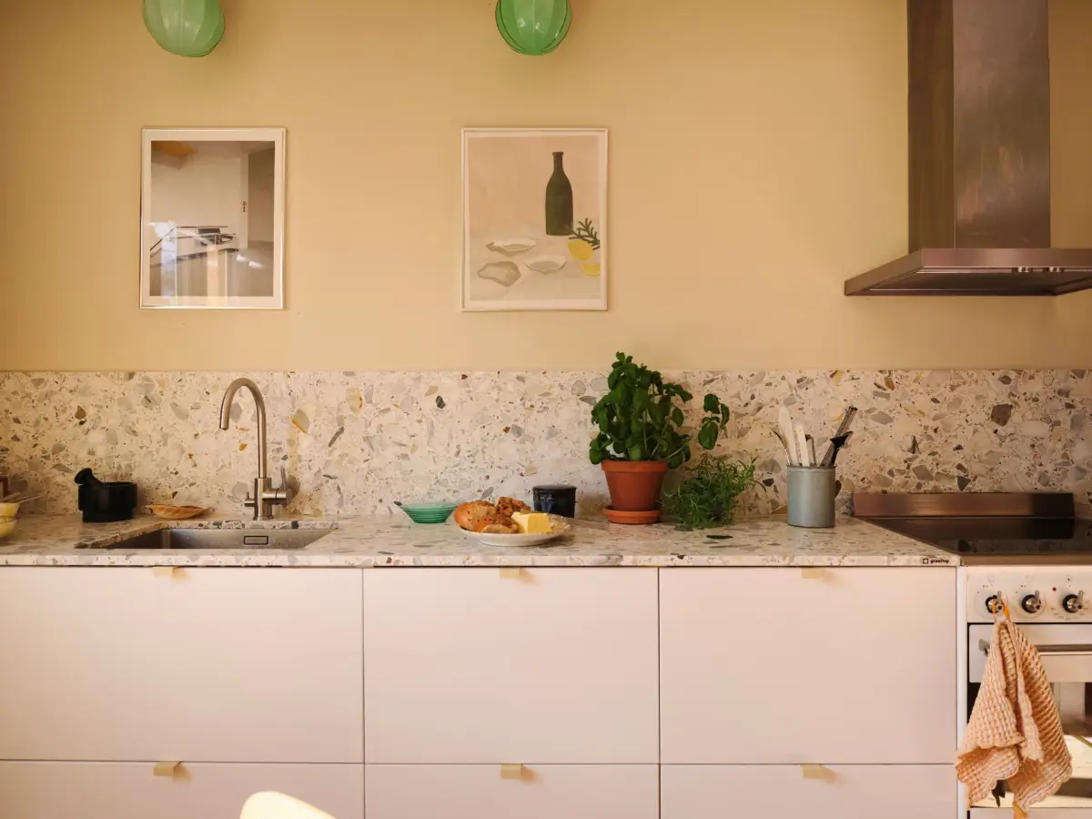 Soft Beige Interiors with the Occasional Bright Color Pop in Stockholm 13 white kitchen cabinets terrazzo countertop
