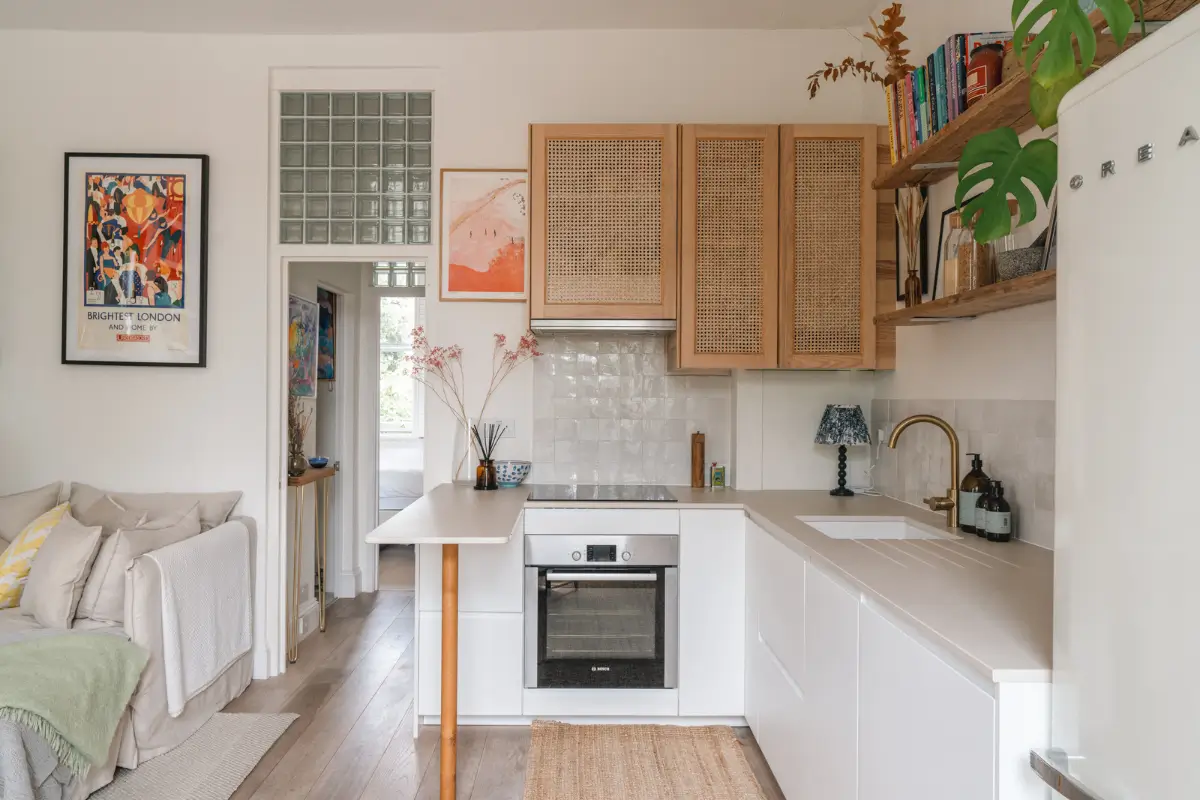 A Bright and Cozy One-Bedroom Apartment in London 7 white kitchen cane upper cabinet